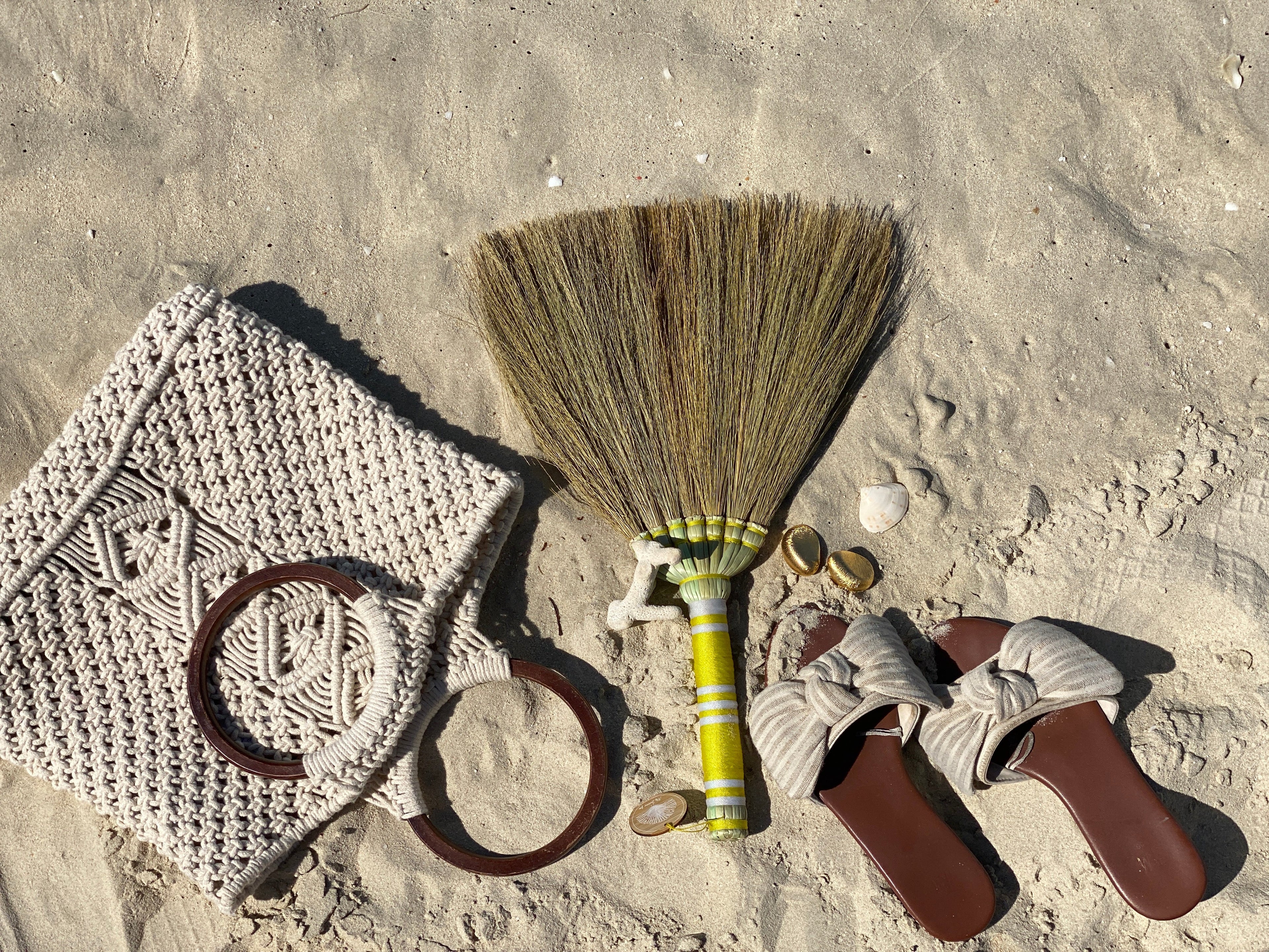 Anti sand brush, woven bag, and sandals on sand